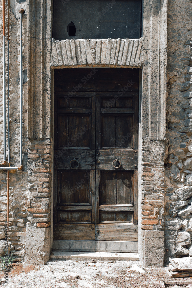close-up image of ancient closed doors. Old Italy. Background. Lock. vintage, retro. vertical photo close-up image of ancient closed doors. Old Italy. Background. Lock. vintage, retro. vertical photo