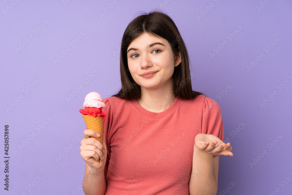Young Ukrainian teenager girl holding a cornet ice cream over isolated purple background making doubts gesture while lifting the shoulders Young Ukrainian teenager girl holding a cornet ice cream over isolated purple background making doubts gesture while lifting the shoulders