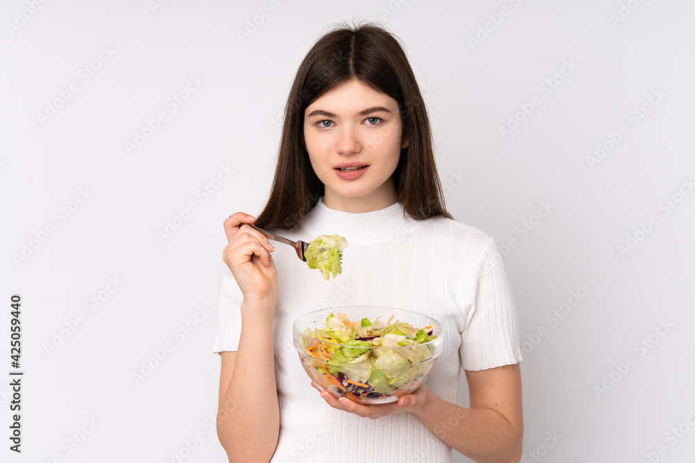 Young Ukrainian teenager girl holding a salad over isolated white background Young Ukrainian teenager girl holding a salad over isolated white background