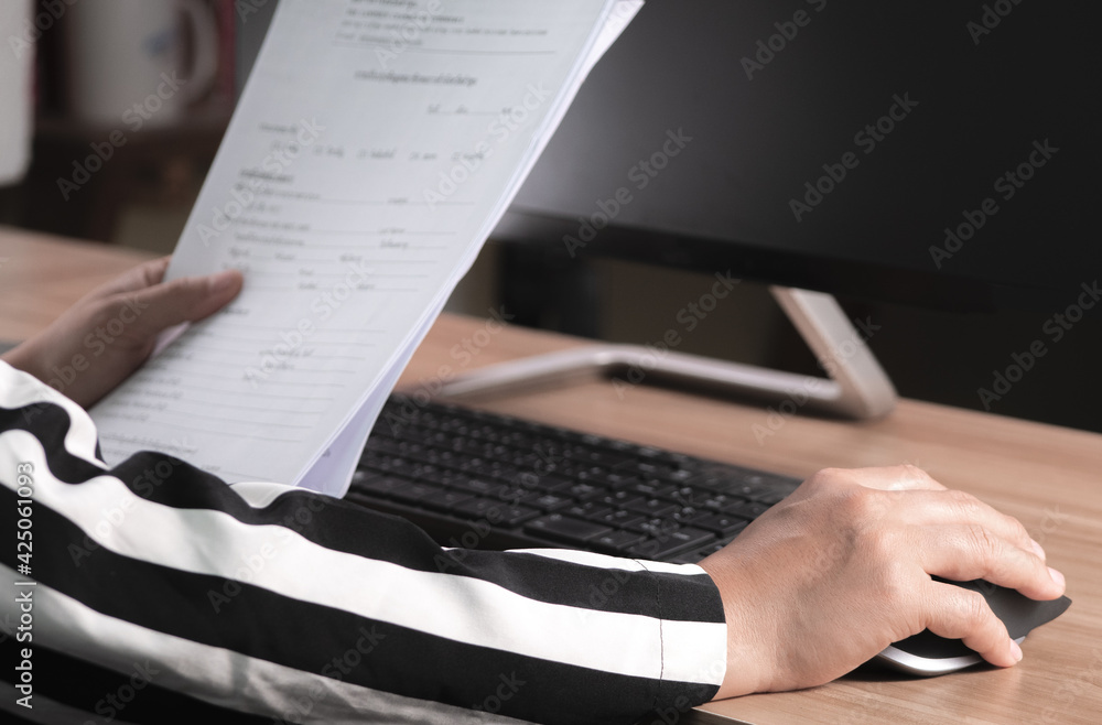 Close up Hand of young business woman working on a laptop computer sit at desk in her office.