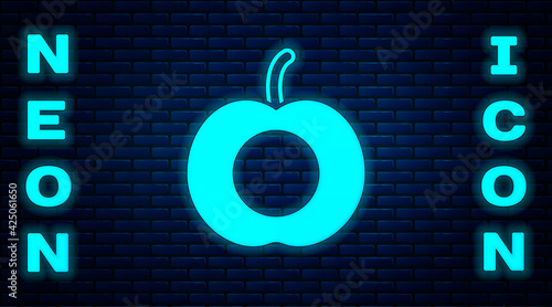 Glowing neon Peach fruit or nectarine with leaf icon isolated on brick wall background. Vector