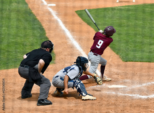 Photography Action photo of athletic high school baseball player making an amazing play duri