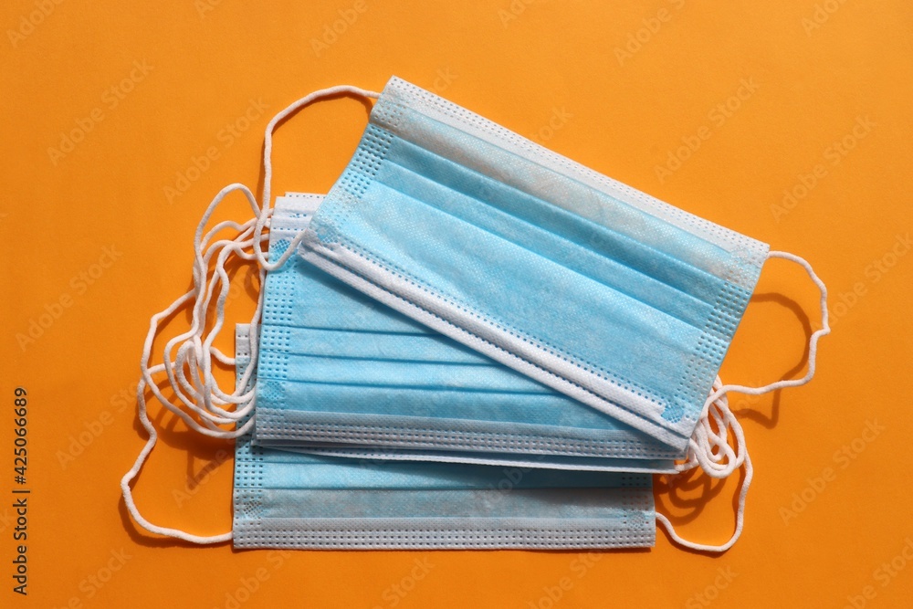 Stack of blue medical hygienic mask on colored backdrop. Protective pandemic face masks on yellow background. Pile of disposable surgical face mask against coronavirus, covid-19. Top view, copy space
Stack of blue medical hygienic mask on colored backdrop. Protective pandemic face masks on yellow background. Pile of disposable surgical face mask against coronavirus, covid-19. Top view, copy space