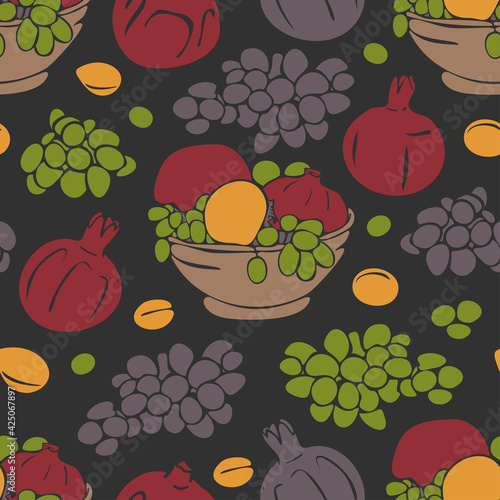 Vector seamless pattern with pomegranates, persimmon and grapes in bowl. Fruits on dark background.