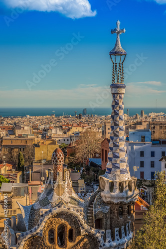 Canvas Print Park Guell with panoramic view onto the skyline of Barcelona with fluffy clouds
