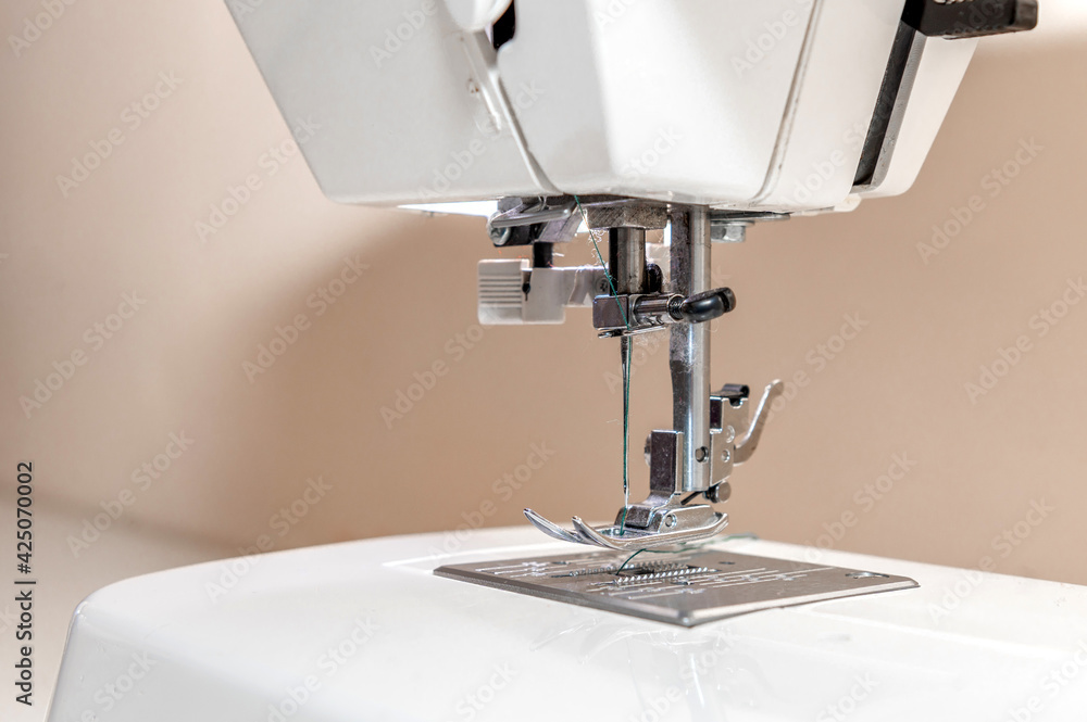 Sewing hobby background. Close up process of sewing on a sewing machine with copy space.