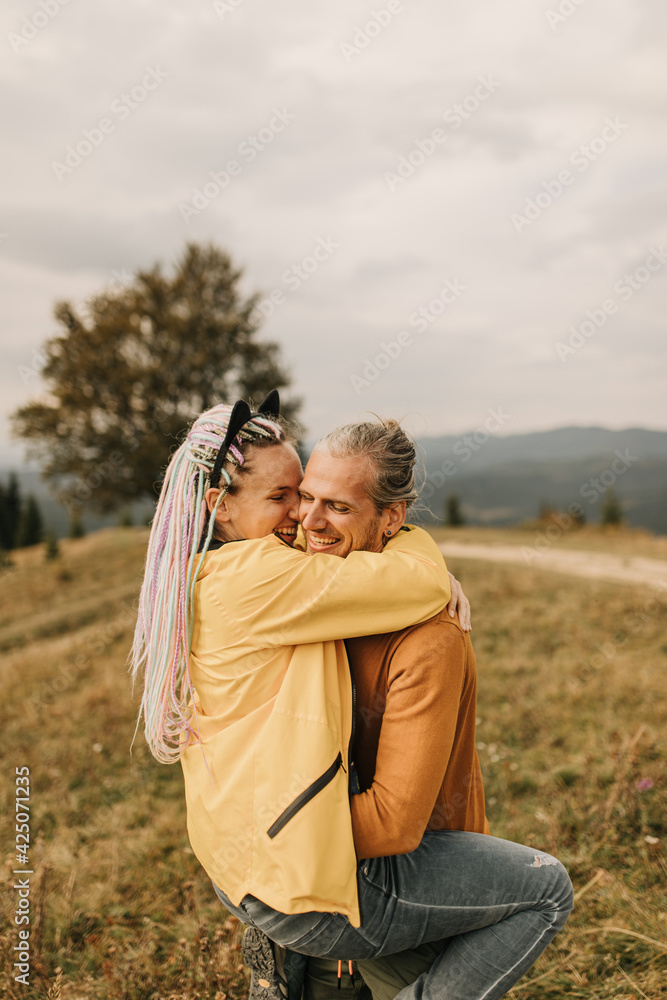 couple in love enjoying each other and walking in the mountains