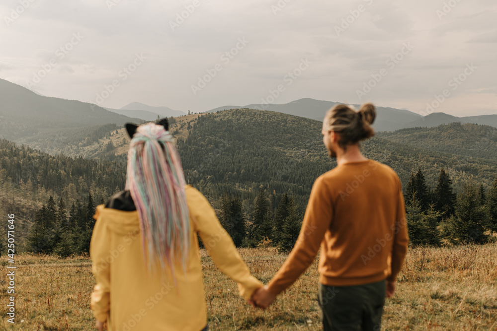 couple in love enjoying each other and walking in the mountains