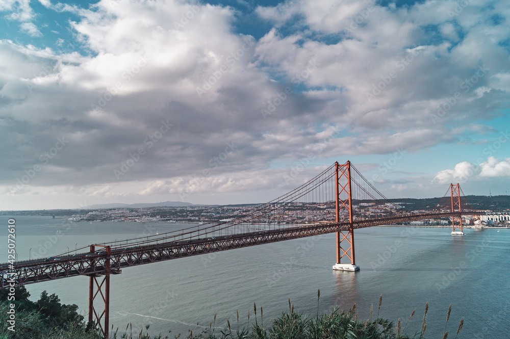 Obraz premium A view of the Tagus river and bridge the 25 April in Lisbon, Portugal