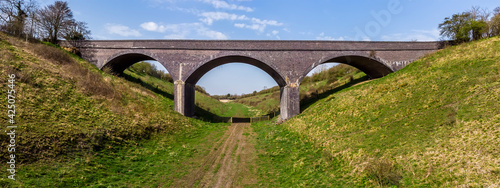 A view towards a Victorian viaduct near to Helmdon village, Northamptonshire, UK on a bright Spring day photo