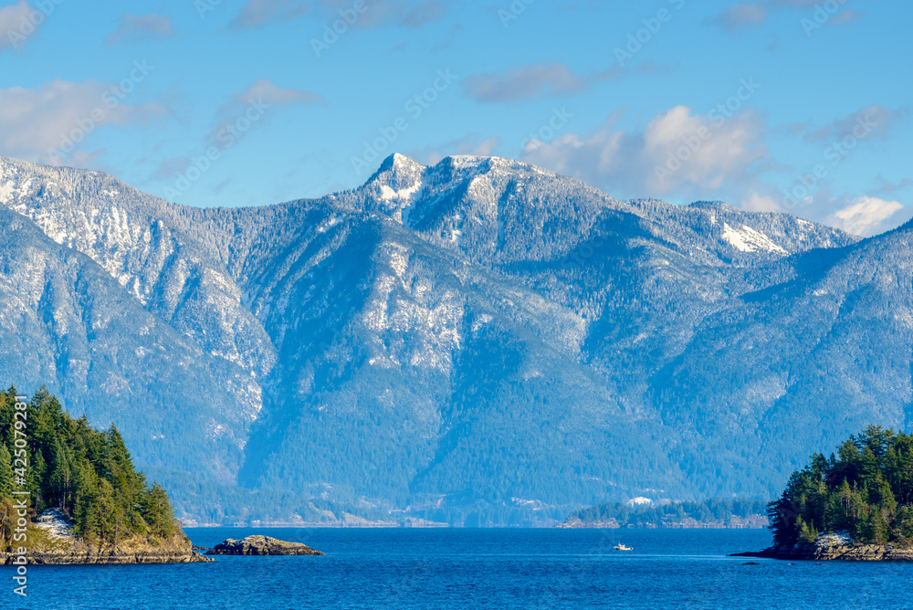 Fantastic view over ocean, snow mountain and rocks at Sechelt inlet in Vancouver, Canada.