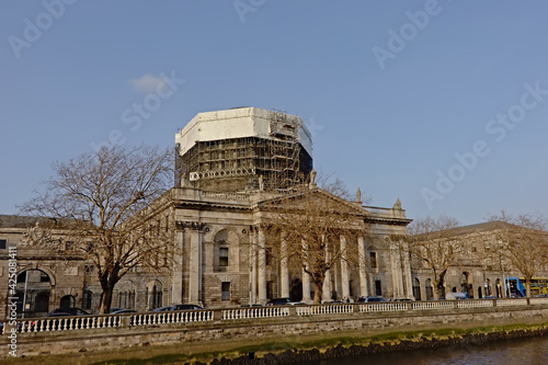 Four courts neoclassical justice building along river Liffey under renovation, Dublin, Ireland
