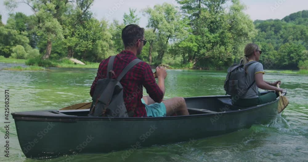 Couple kayaking on lake on river and having adventure in nature Couple kayaking on lake on river and having adventure in nature