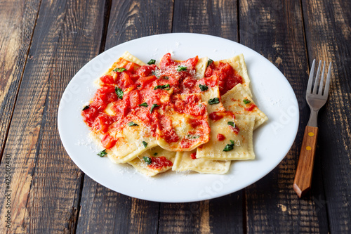 Ravioli with tomato sauce, spinach and parmesan cheese. Healthy eating. Vegetarian food. Italian cuisine.
