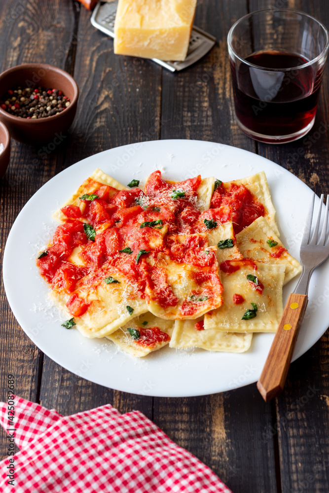 Ravioli with tomato sauce, spinach and parmesan cheese. Healthy eating. Vegetarian food. Italian cuisine. Ravioli with tomato sauce, spinach and parmesan cheese. Healthy eating. Vegetarian food. Italian cuisine.
