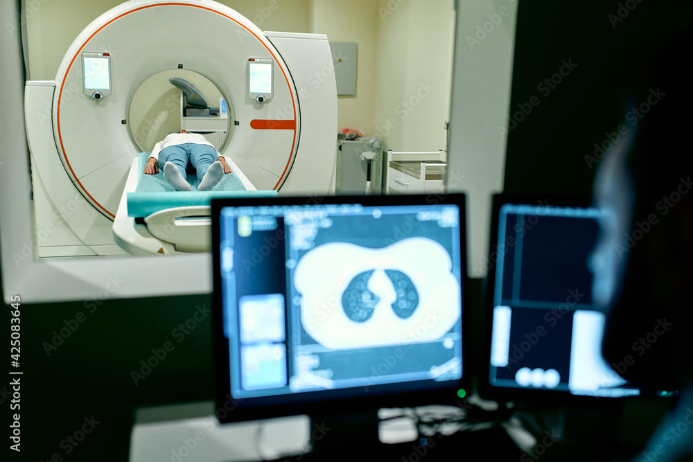 In the medical laboratory, the patient undergoes an MRI or CT scan ...