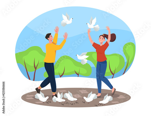 Lovers couple walking park and feed white pigeons.