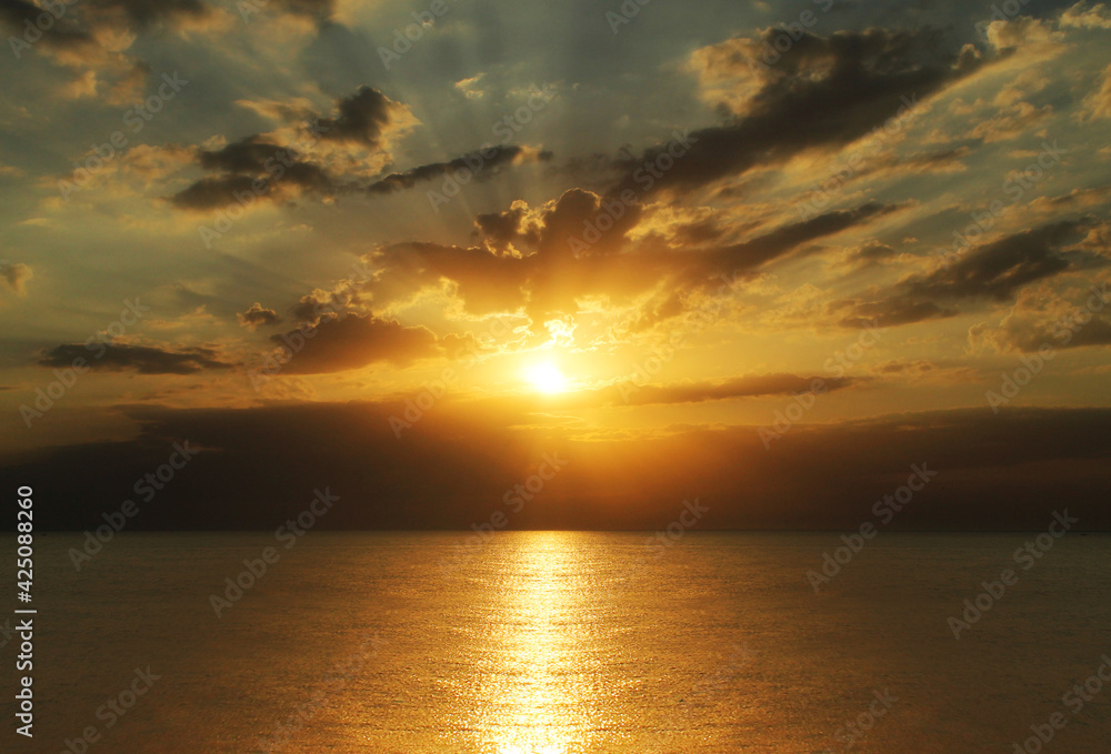 Beautiful orange sunset on a sea voyage. Calm evening sea.