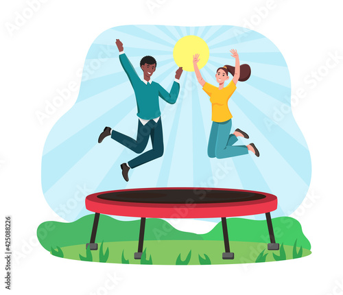 Multiracial couple are jumping on trampoline.