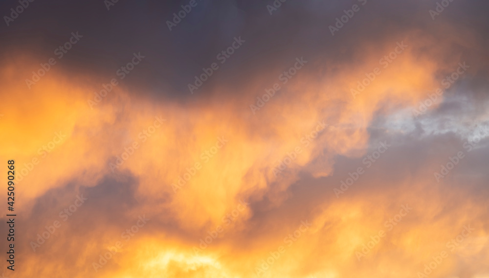 Sunset sky background. Beautiful sunset with bright dramatic clouds.