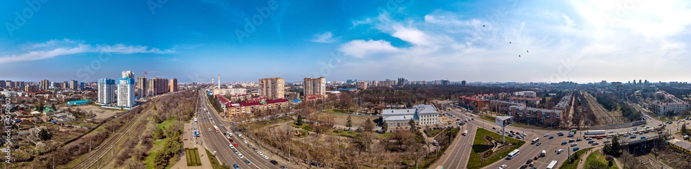 urban aerial landscape on a sunny day - industrial area with a park and old abandoned factories on the northern outskirts of Krasnodar city and near the railway and highway