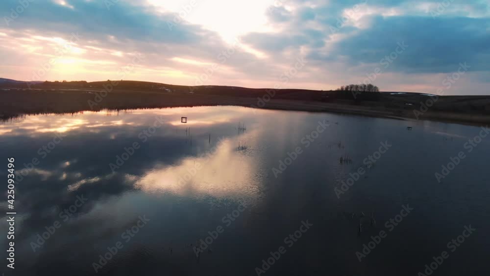 At sunset aerial copter view of beautiful lake. Top view. Nature, beautiful, travel, drone, scenic, panorama, tree, wilderness, natural, environment, wood, countryside. Slow motion At sunset aerial copter view of beautiful lake. Top view. Nature, beautiful, travel, drone, scenic, panorama, tree, wilderness, natural, environment, wood, countryside. Slow motion