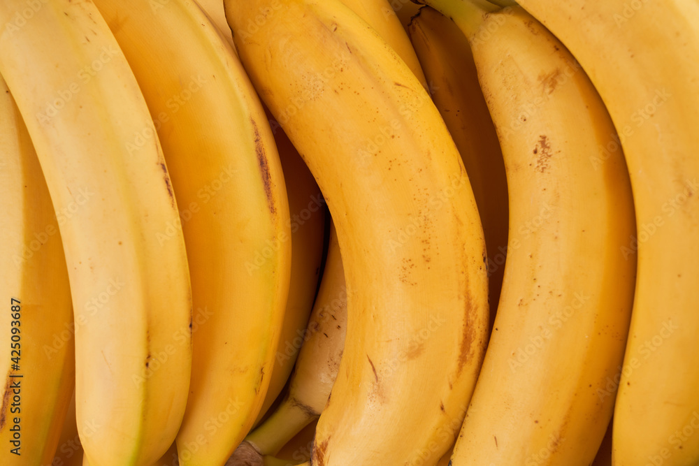 Yellow whole bananas close up background