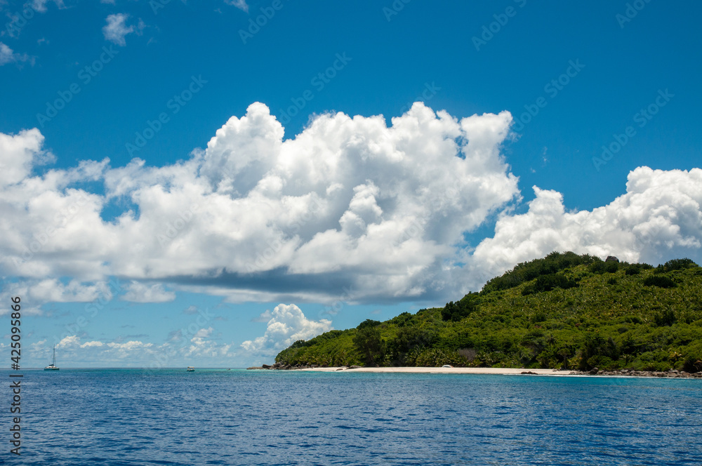 Granite coastline view of the tropical island of Marianne in Seychelles with blue sky Granite coastline view of the tropical island of Marianne in Seychelles with blue sky