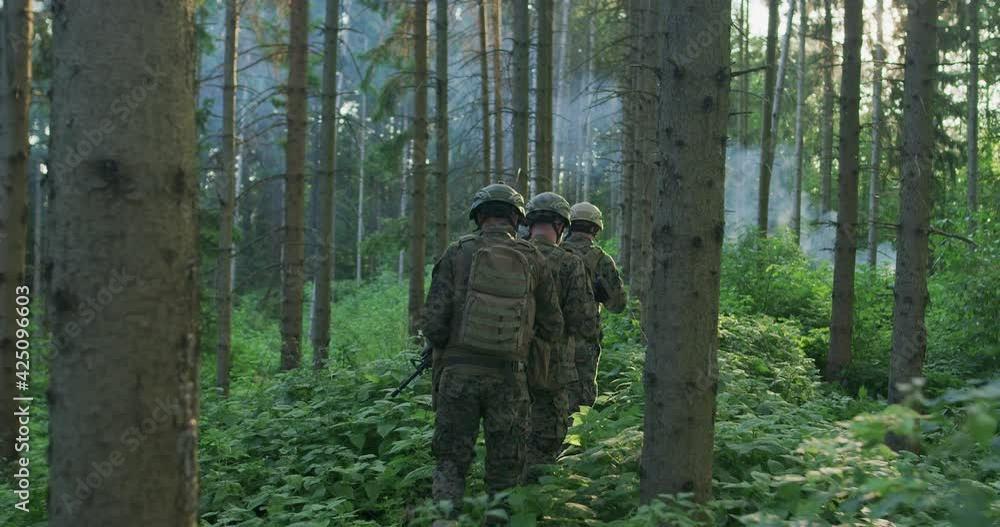 Millitary operation with gorup of soliders attacking enemy line in dense forest during day time Millitary operation with gorup of soliders attacking enemy line in dense forest during day time