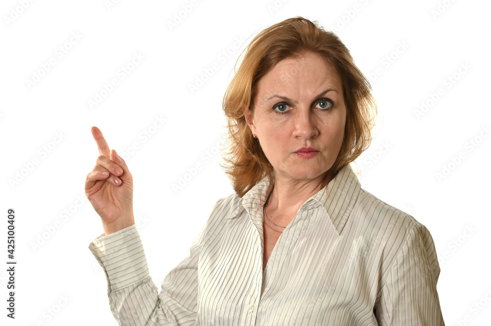 A business woman in a light blouse looks at the camera and points to something to her right A business woman in a light blouse looks at the camera and points to something to her right