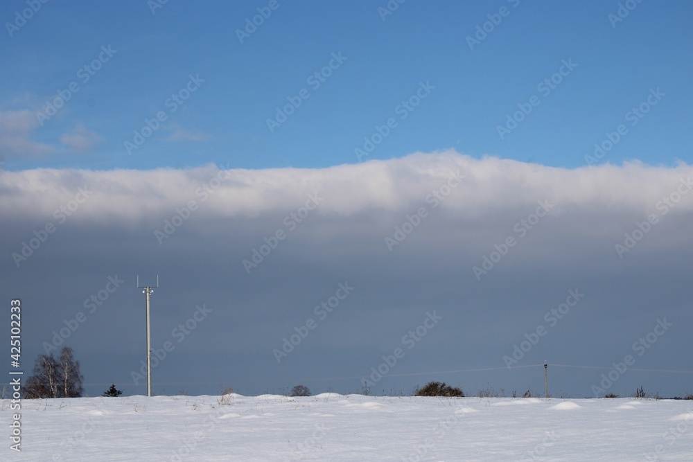 cloud scenery with a lamp post in the foreground