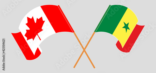 Crossed and waving flags of Canada and Senegal
