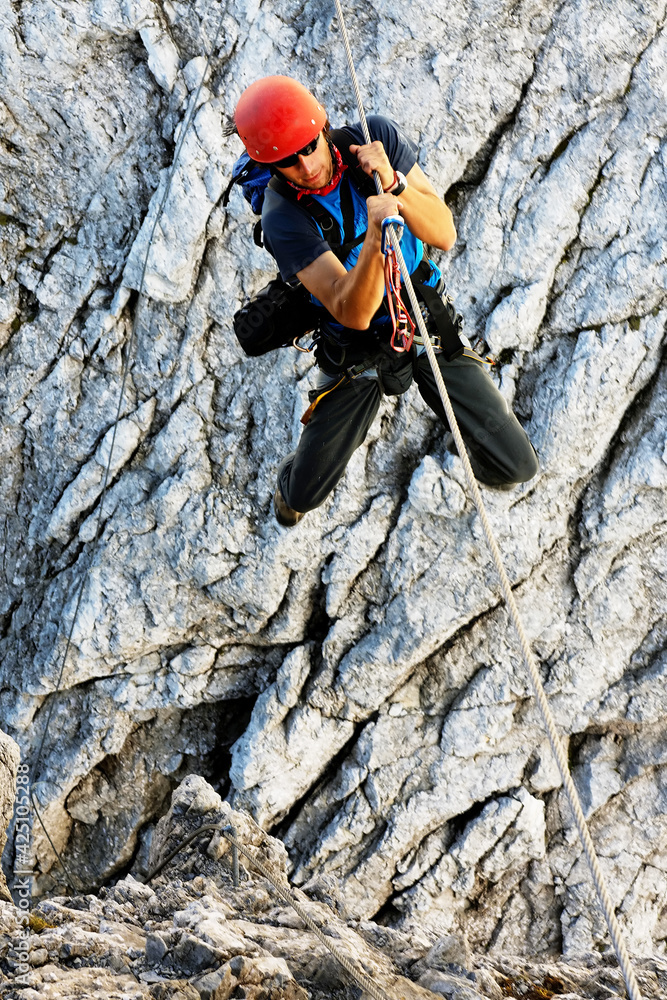 Young alpinist climbing on Koenigsjodler Ridge, Austrian Alps, Europe Young alpinist climbing on Koenigsjodler Ridge, Austrian Alps, Europe