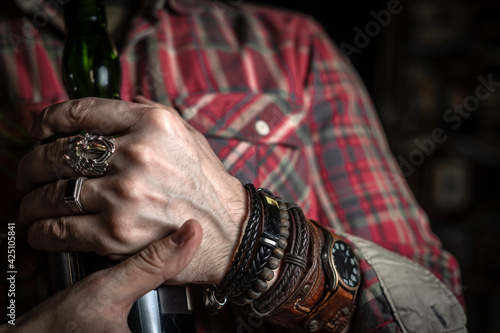 Stylish man wears wrist wooden and leather bracelets