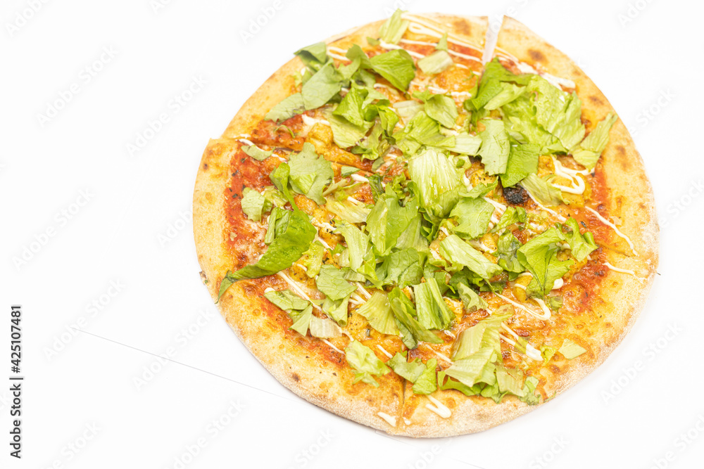 Pizza with lettuce and chicken meat isolated above white background Pizza with lettuce and chicken meat isolated above white background