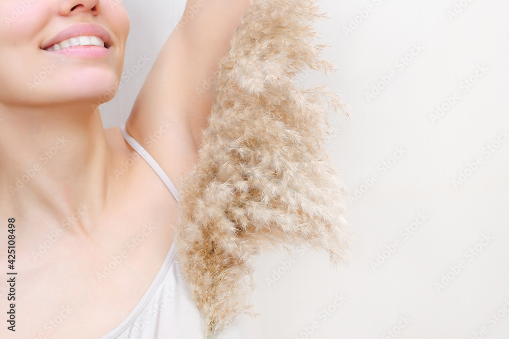 Young woman holding her hands up and showing armpits