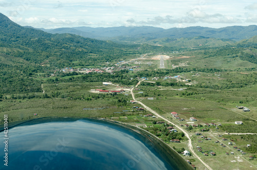 Final approach runway 22 at Long Bawang, northern Kalimanantan, as seen from the right seat of a Cessna Caravan. The Malaysian border starts just over the distant ridge. photo