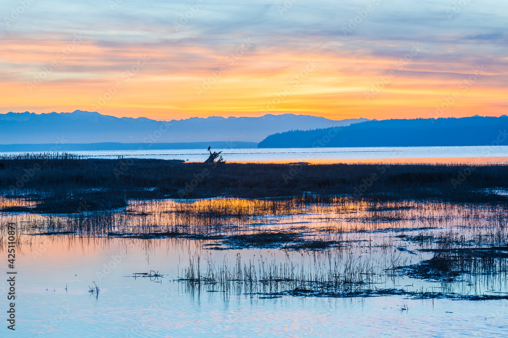 Peaceful sunset across Skagit Bay with a view of the distant Olympic Mountain Range Peaceful sunset across Skagit Bay with a view of the distant Olympic Mountain Range