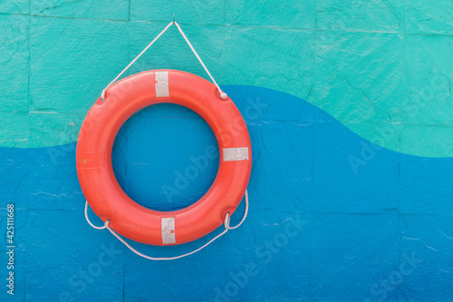 Lifebuoy hanging on a colorful wall