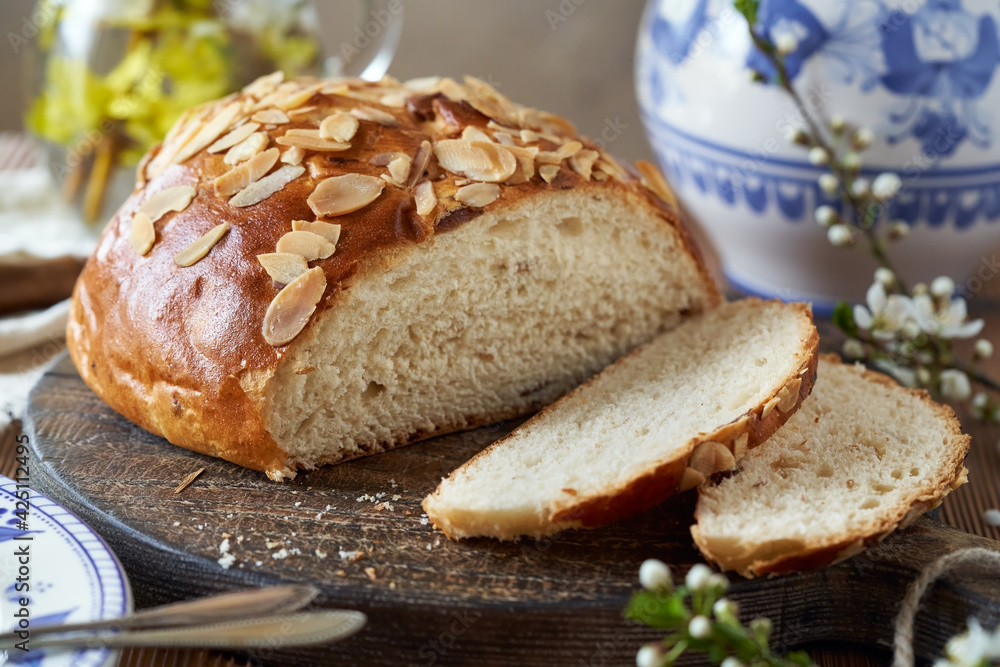 Sliced mazanec, traditional Czech sweet Easter pastry, similar to hot cross bun, with spring  blossoms