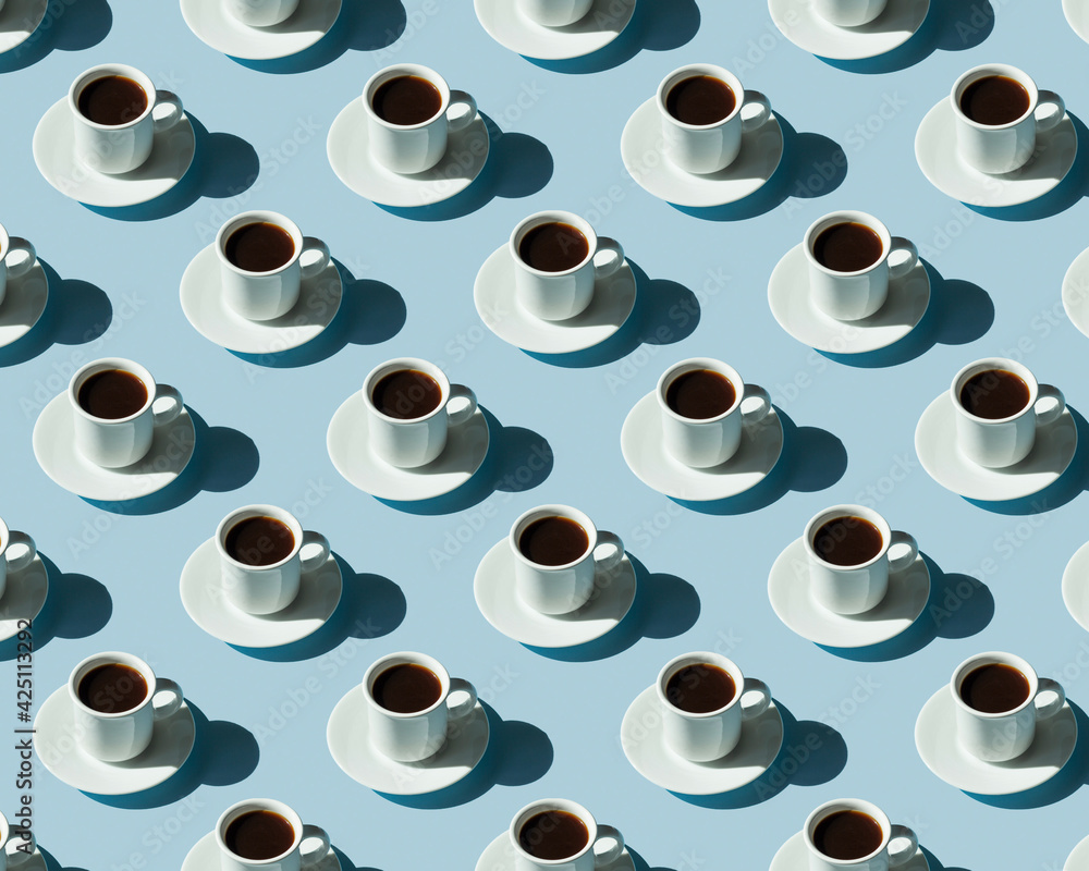 Rhythmic pattern from cups with coffee on a blue background.