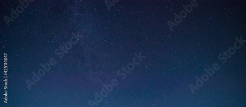 Panorama blue night sky on dark background.Universe filled with stars  nebula and galaxy with noise and grain.Photo by long exposure and select white balance.selection focus.amazing.