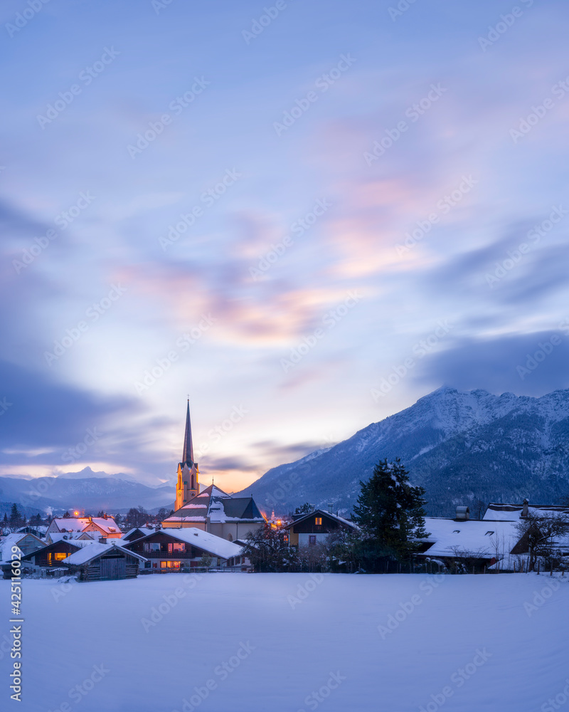 Beautiful winter cityscape with church tower illuminated at sunrise - Garmisch-Partenkirchen