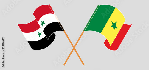 Crossed and waving flags of Syria and Senegal