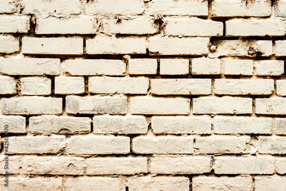 Texture of a brick wall with cracks and scratches which can be used as a background Texture of a brick wall with cracks and scratches which can be used as a background