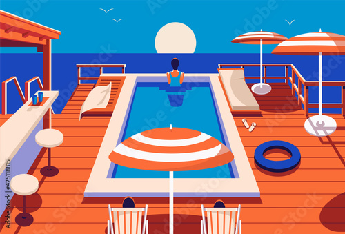 Swimming pool in the hotel with sun beds and umbrellas.