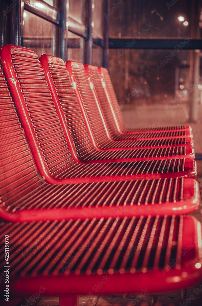 Red seats at the train station. - obrazy, fototapety, plakaty 