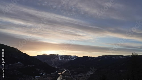 Sunset in the mountains. Sun peaks out from the sky before it sets behind again. Time lapse. Shot in Hallingdal, Norway during Easter.