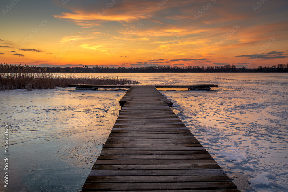 beautiful, fabulous sunset over the frozen lake and the pier - Lake Rotcze