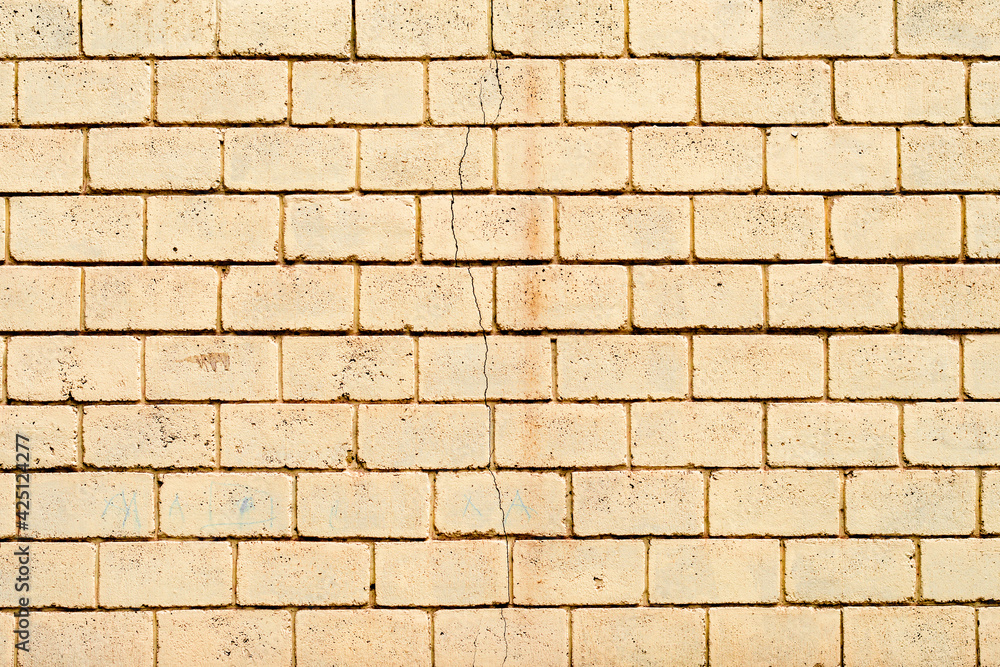 Obraz premium Texture of a brick wall with cracks and scratches which can be used as a background